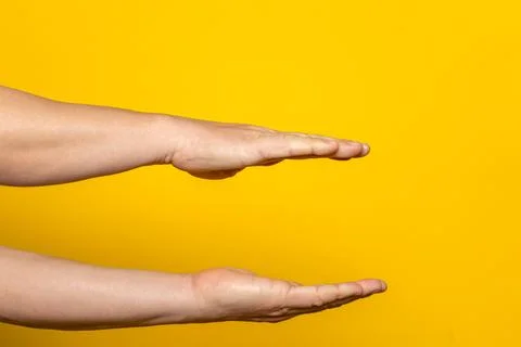 Strong hands of man in parallel offering something imaginary inside, advert.. Stock Photos