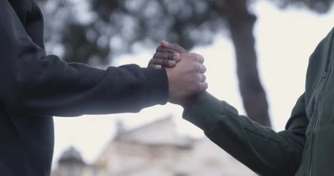 Strong handshake between diverse men showing unity and solidarity Stock-Footage 333199269