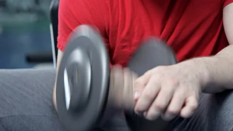Strong handsome athletic man doing weightlifting and exercising biceps Stock Footage 106735100