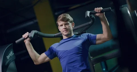 Strong Handsome Male Closeup Using Pull Down Machine Upper Body Strength 動画素材 103848818