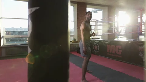 Strong kickboxer black man training punching bag. Video stock 101528322