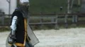 Strong knight comes to battlefield and waits for his rival. Medieval tournament HD Footage
