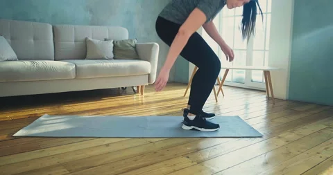 Strong lady lies down on mat do sports exercises in room Stockbeeldmateriaal 153606657