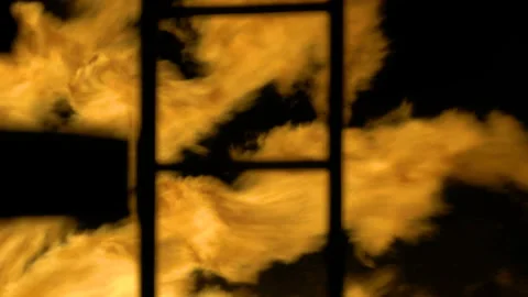 Strong large flames behind black stairs. Metal fire ladder silhouetted against 스톡 동영상 205414606