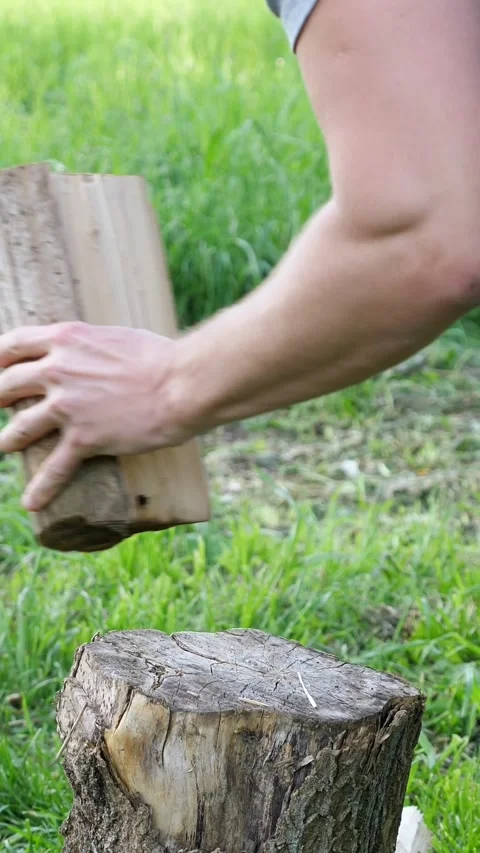 Strong lumberjack splitting firewood with a sharp axe, preparing wood for winter Stock-Footage 341283393