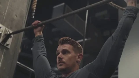 Strong male athlete doing pull-ups Stock Footage 76724271