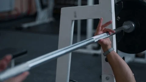 Strong male bodybuilder doing bench press exercise with heavy barbell in gym Video stock 81413778