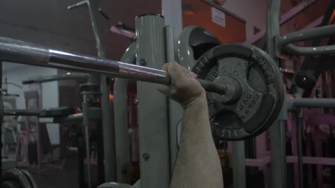 Strong male bodybuilder doing bench press exercise with gym Stockbeeldmateriaal 83062209