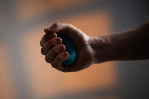 Strong Male Hand Using Hand Exerciser Fotos Stock