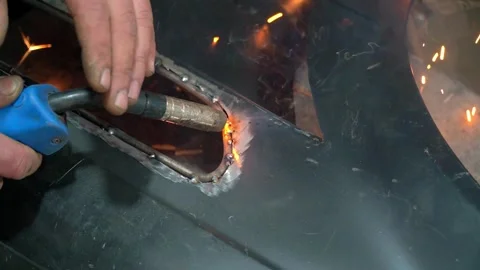 Strong male hands close-up without gloves produce welding of metal structures Stock Footage 275399609