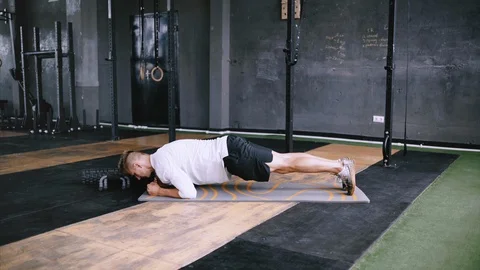 Strong man does plank saws, exersize at gym. Stock Footage 112062568