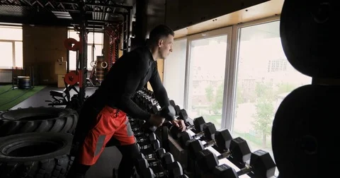 Strong man doing exercise with dumbbells Stock Footage 75876441