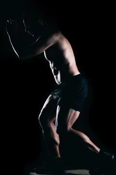 Strong man doing exercises on top of a box. Stock Photos