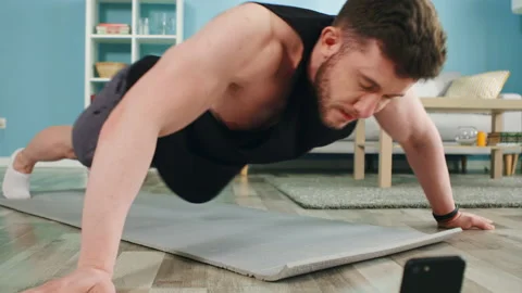 Strong Man Is Doing Intese Workout at Home Stock Footage 135537827