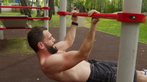Strong Man Doing Inverted Rows Outdoors Video stock 329599255