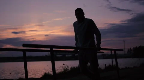 Strong Man doing Pull Ups Outdoor under very Hot Sun in a park Stock Footage 64021828