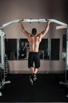 Strong man doing pull ups Stock Photos
