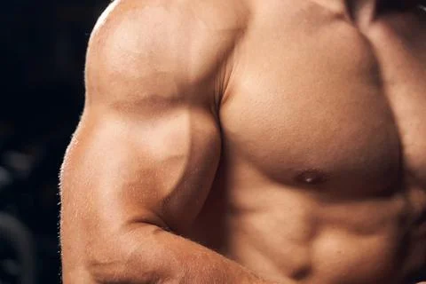 Strong man flexing his arm and chest muscles Stock Photos