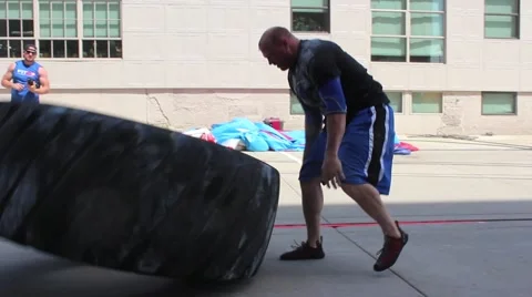 Strong Man Flipping Tire Stock Footage 68800838