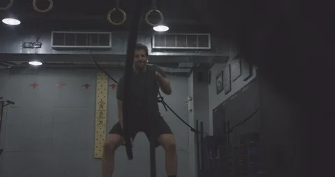 Strong Man in Gym Using Ropes to Exercise Stock Footage 94965481