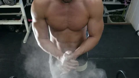 Strong man handles talc hands Stock Footage 75807539