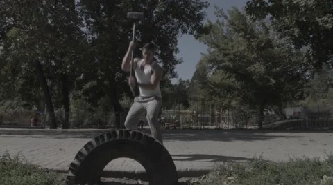Strong man hitting with a hammer (BMCC 2.5K - 2400x1350) Stock Footage 47957418