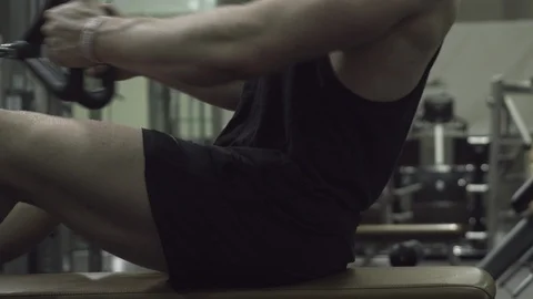 Strong man muscly bodybuilder working out on back with pulls  Stock Footage 85655841