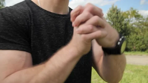 Strong man with muscular does warm-up stretching hands arms before training. Stock-Footage 131393154