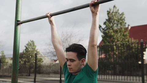 Strong man performing exercises on the uneven bars Stock Footage 107227477