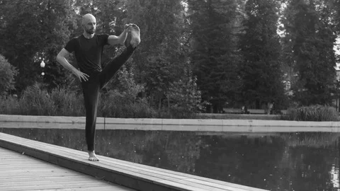 Strong man performing one-leg standing balance Stock Footage