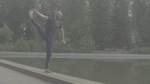 Strong man performing one-leg standing balance Stock Footage