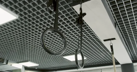 Strong man performing pull ups on gymnastic rings. Slow motion Stock Footage 116509571