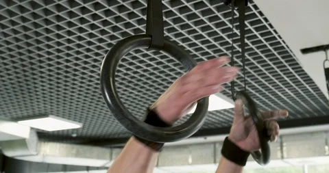 Strong man performing pull ups on gymnastic rings. Slow motion Stock Footage 116618265