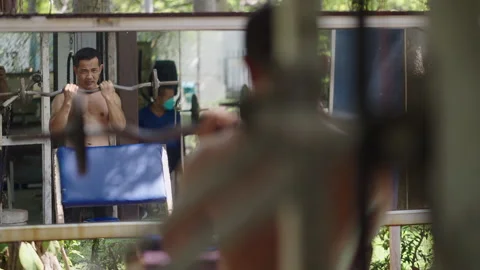 Strong man performs a biceps exercise Stock Footage 265584860