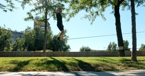 Strong Man Practicing As Acrobat With Trickline Outdoors Stock Footage 111232269