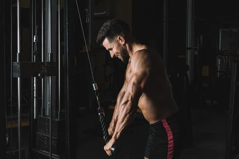 Strong man pulling from a weigh machine in a gym Stock Photos