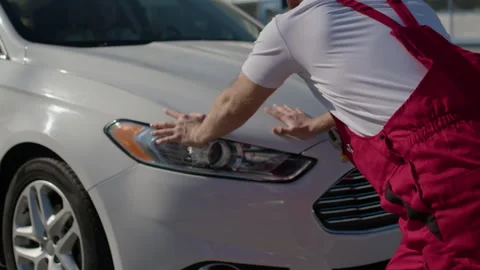 Strong man pushes broken car with determination his muscles flexing man pushes Stock Footage 270950367