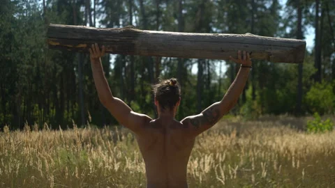 A strong man raises a tree, A man goes in for sports in the open air Video stock 93275718