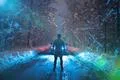 The strong man stand against the car on the forest road. evening night time Photo