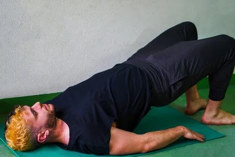 Strong man stretching doing the bridge position Stock Photos