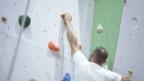 Strong Man Training Climbing On Indoor Climbing Wall Stock Footage 123279145