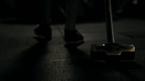 Strong man in training with a hammer and wheel Stock Footage 88931144