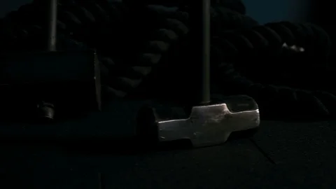 Strong man in training with a hammer and wheel Stock Footage 88931350