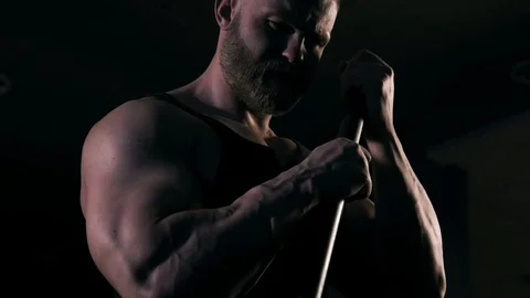 Strong man in training with a hammer and wheel Stock Footage 89604874