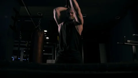 Strong man in training with a hammer and wheel Stock Footage 89605150