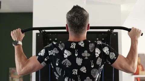 A strong man trains pull-ups. Pull-up exercise in the gym or office for Stock Footage 144557980