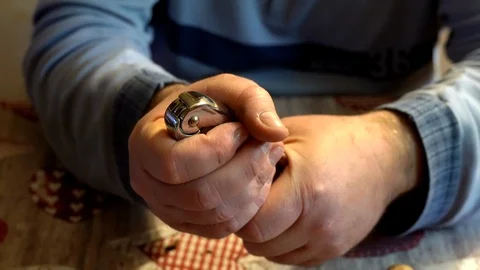 Strong man using metal cracker for peeling walnuts. Dry fruit, cracking nuts Stock Footage 124392964