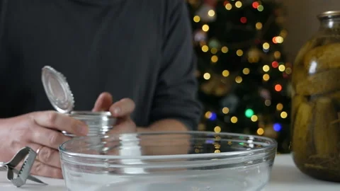 Strong man using opener hands cutting the lid of a metal can on a table with Stock Footage 146404235