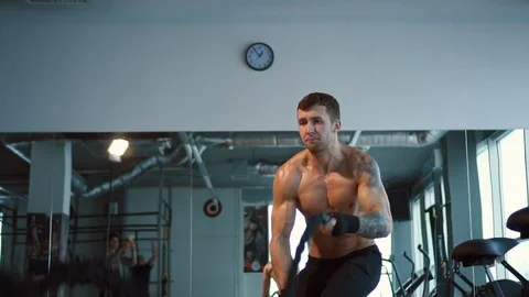 Strong man working out with Battle Ropes, slow motion Stock Footage 100713041