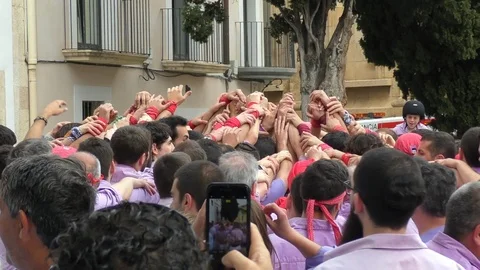 Strong men build lower level of human castle in Catalonia Stock-Footage 103299606